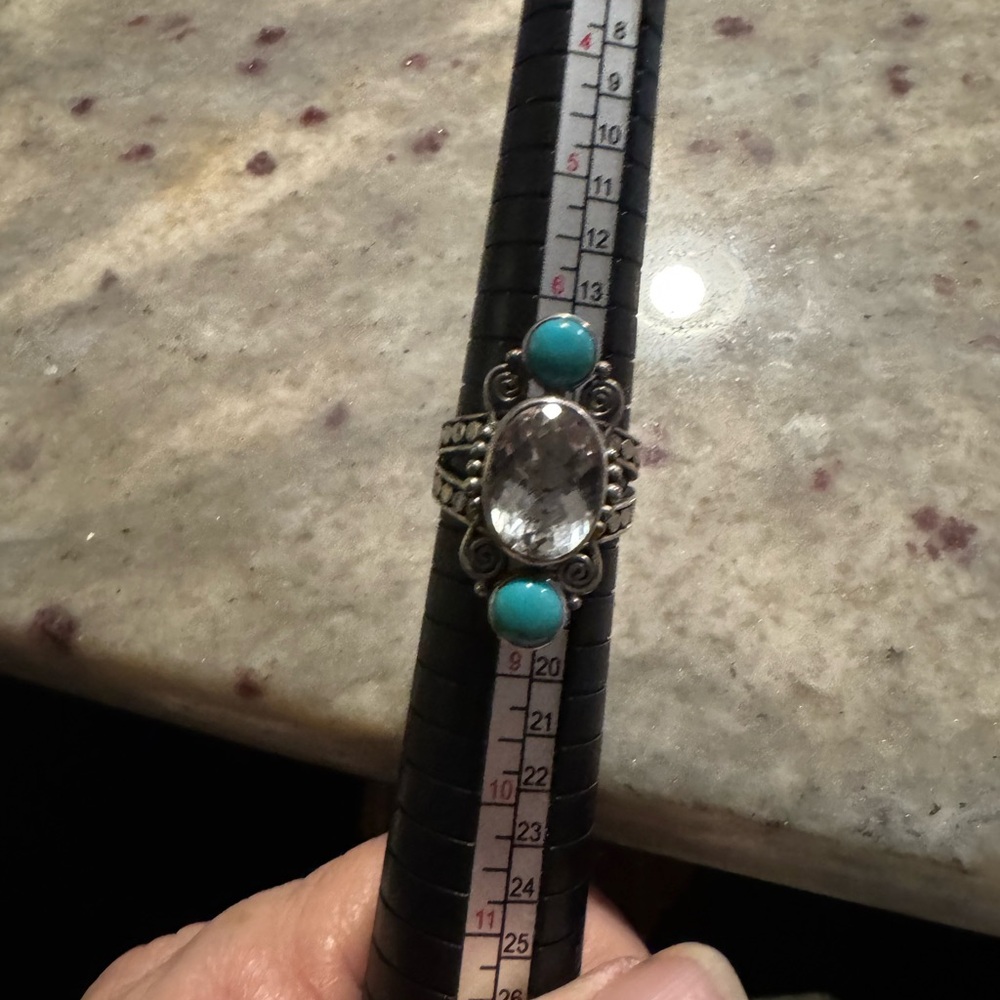 Elegant Sterling Silver and Turquoise with clear stone in the center. Size 7 1/2